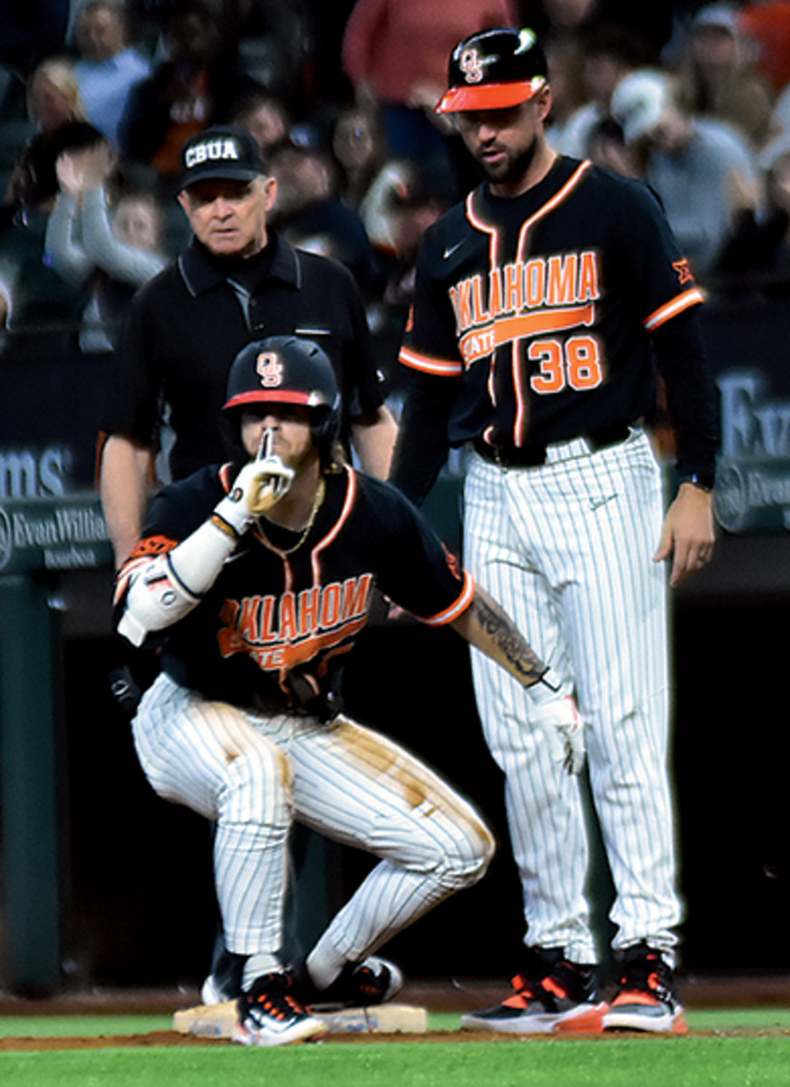 Oklahoma State's Roc Riggio tells the Arkansas crowd to shush after his first hit of the game.